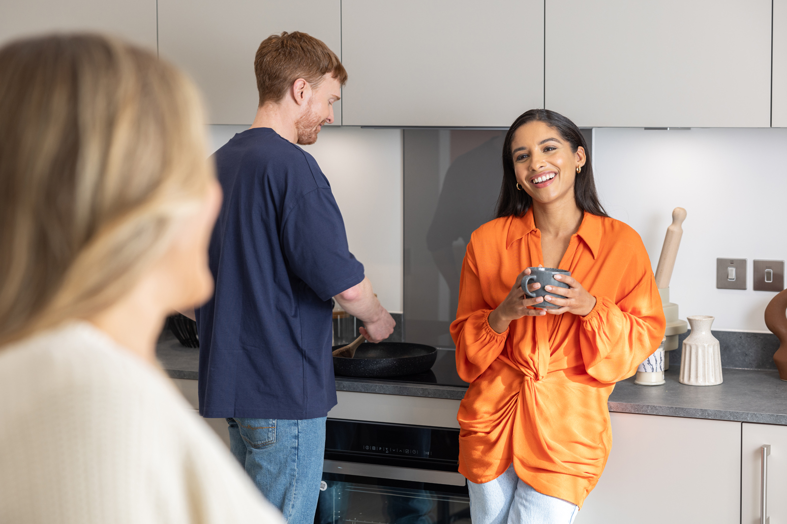 Couple talking with friends in kitchen
